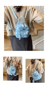 Detail of light blue floral mini backpack featuring tulip patterns and adjustable straps