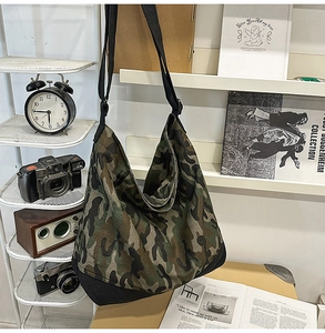 Detail of camoflauge canvas tote bag with adjustable wide strap and black base
