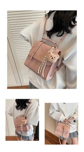Pink croc-texture shoulder bag with cute bear charm and striped scarf detail on strap