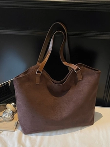 Deep brown faux suede tote bag with laptop and books for a casual commuter style look