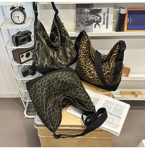 Three oversized canvas hobo bags in camouflage and leopard prints with wide straps