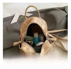 Internal capacity of mini floral backpack showing storage for phone and cosmetics