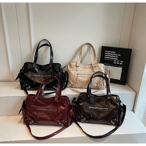 Detail view of four large tote bags in black, cream, burgundy and coffee leather finishes