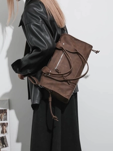 Brown vintage travel tote bag in matte leather finish shown in lifestyle setting