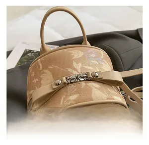 Close-up of beige crossbody bag with textured fabric, bow detail and silver hardware