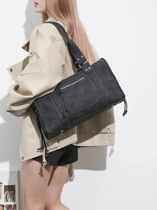 Chic black matte leather oversized travel tote bag with woven stripes and side drawstrings