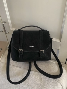 Vintage black faux leather backpack with double strap buckles and flap top design