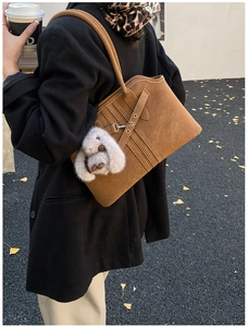 Vintage brown suede tote bag with decorative stitching and a cute bunny charm