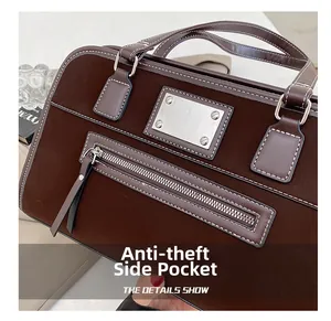 Detail showing anti-theft side pocket and contrast stitching on dark brown suede boston bag