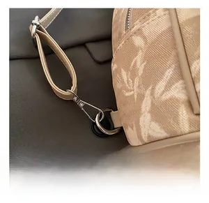 Detail of leaf print fabric with premium silver metal hooks and sturdy canvas straps