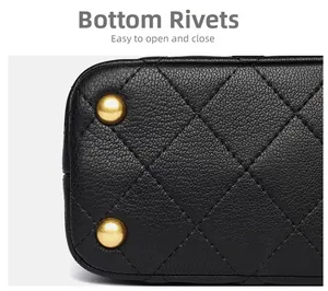 Detailed macro view of black quilted leather texture and protective gold metal studs