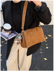 Brown quilted suede shoulder bag with a cute plush bear pendant shown on a street model