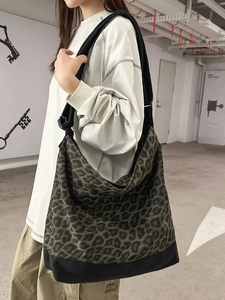 Large leopard print canvas hobo bag with black bottom panel for casual everyday use