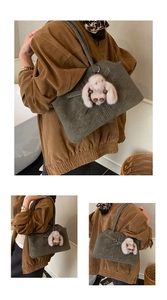 Detail of retro olive green tote bag featuring matte texture and plush rabbit pendant