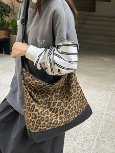 Large leopard print canvas tote bag with adjustable black strap for casual street style