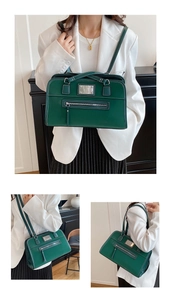 Detail of vintage dark green tote bag with silver hardware on office style model
