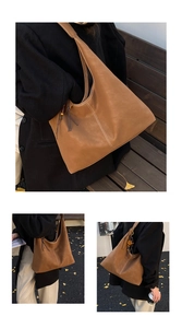 Detail of vintage brown tote bag with white contrast stitching and tassel charm