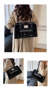 Detail of vintage black patent leather tote bag with contrast stitching and silver hardware