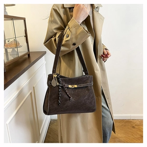 Dettaglio della borsa tote in pelle scamosciata marrone scuro con fibbia in metallo