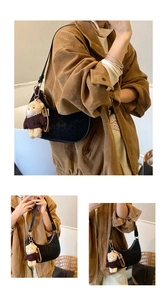 Detail of black faux leather hobo bag with subtle leopard print and cute bear charm