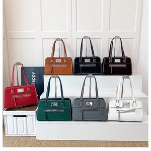 Multiple color options of structured leather tote bags showing glossy finish and metal details