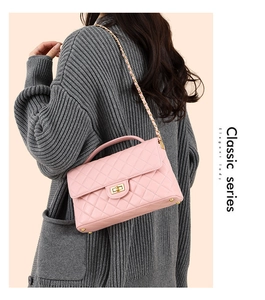 Detailed close-up of a pink quilted crossbody bag with a gold turn-lock and chain strap