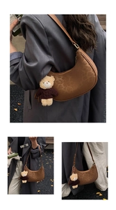 Brown leopard print hobo bag with teddy bear charm and adjustable leather strap