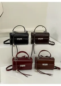 Four versatile small square crossbody bags in black, burgundy, dark brown and tan