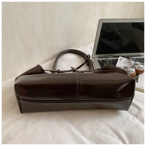 Detail of the reinforced stitching and wide bottom on this vintage brown oil wax leather tote