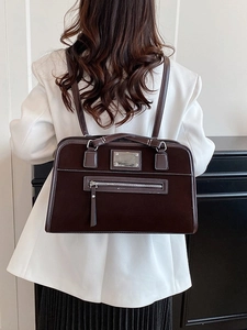 Retro dark brown suede tote bag for women shown as a shoulder bag on a white blazer