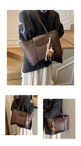 Detailed macro of vintage coffee tote bag featuring lychee grain faux leather and bear charm