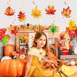 Thanksgiving party decorations with fall maple leaf hanging swirls and festive ornaments