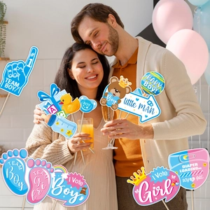 Gender reveal party photo props with Team Boy and Team Girl signs for celebration