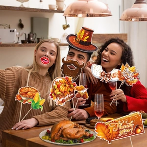 Close-up of Thanksgiving photo booth props with turkey and autumn leaf designs