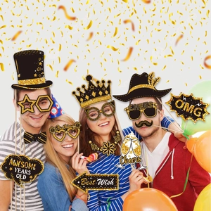 Close-up of black and gold photo booth props with glitter crowns and bow ties