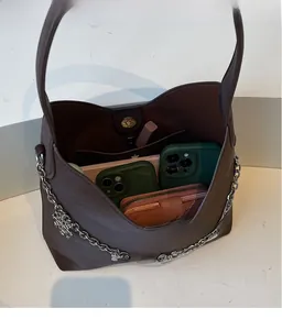 Interior view showing large capacity and chain detail of dark brown bucket bag