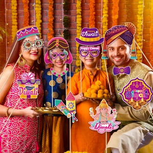 Family holding Happy Diwali photo props like colorful paper glasses and festive hats