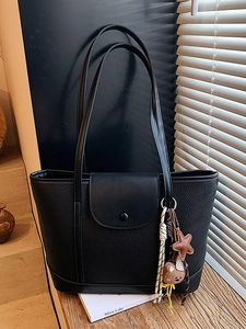 Black vintage tote bag in textured leather with a cute bear and tassel pendant