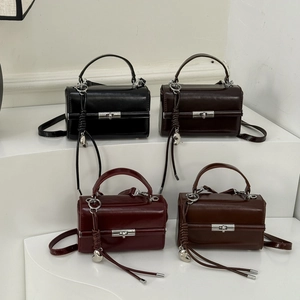 Detailed display of vintage box handbags in four colors with heart charm and metal lock