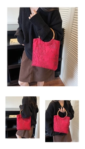 Detailed view of red jacquard tote bag with distinctive circular bamboo handles