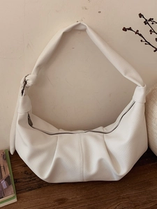 White soft leather pleated crescent bag with oversized shoulder strap and knot detail