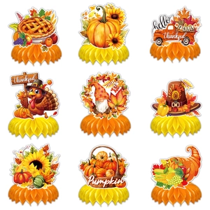 Thanksgiving party table centerpieces with pumpkin, turkey, and autumn maple leaf honeycombs
