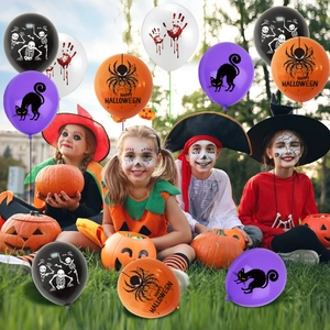 Kids in Halloween costumes surrounded by colorful latex balloons with spooky prints