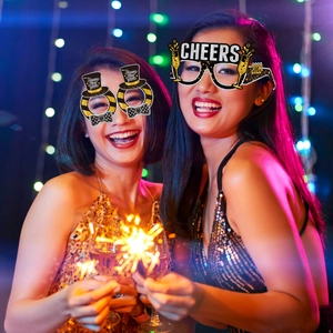 Detail of 2025 New Year party glasses with Cheers and Happy New Year gold lettering