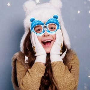 Blue winter hat party glasses with cartoon penguin decoration for Christmas celebration