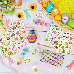Colorful Easter stickers with bunnies and eggs on a white wood table setting