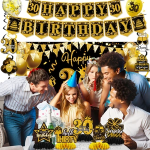 Close-up of black and gold 30th birthday table centerpieces and party decorations