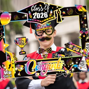 Close-up of Class of 2026 graduation photo props with colorful Congrats frame and masks