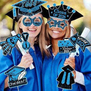 Blue and black glittery Class of 2026 graduation photo booth props held by graduates