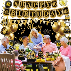 Detailed black and gold 40th birthday party set with banners, balloons and honeycomb centerpieces